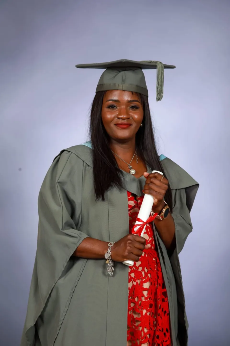 Betty in graduation gown holding her scroll