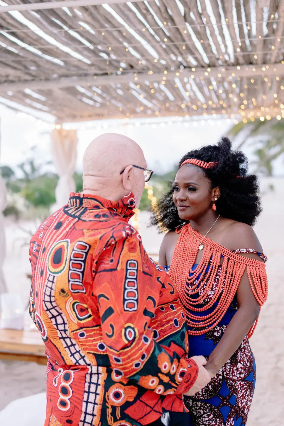 Betty in traditional coral beads facing her partner