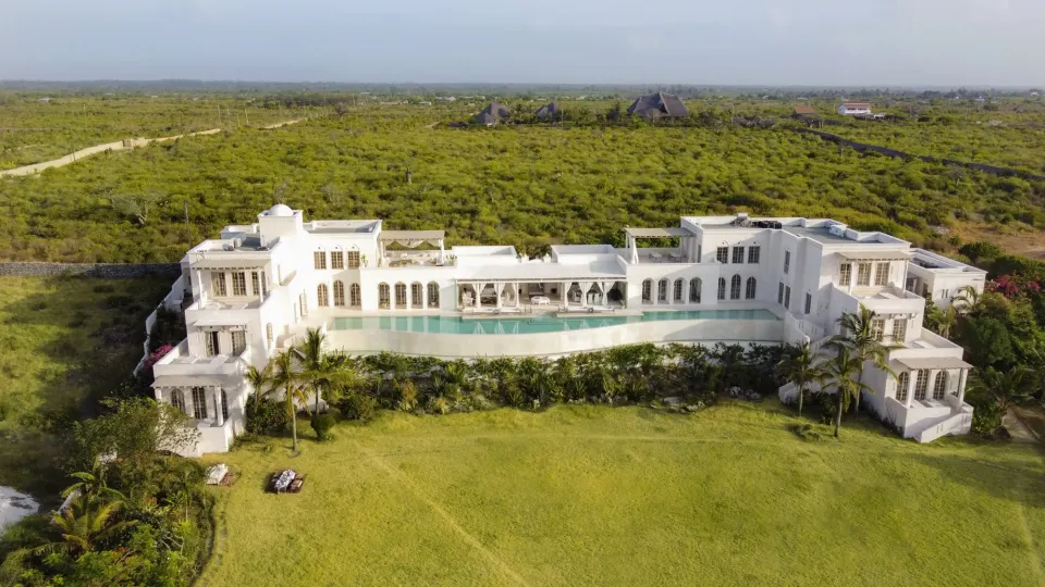 Aerial view of The Beach Palace in its gardens on the coast